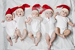 Cute babies with santa hats