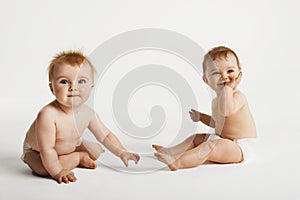 Cute Babies Sitting On White Background