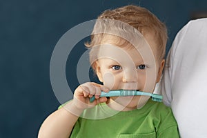 Cute baby 2 years old brushes his teeth with a toothbrush.