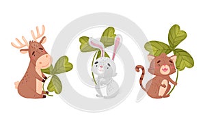 Cute baby animals with three leaf clover set. Adorable deer, bunny, cat holding shamrock leaves cartoon vector