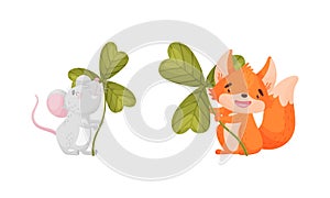 Cute baby animals with three leaf clover set. Adorable mouse, fox holding shamrock leaves cartoon vector illustration