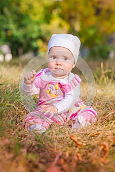 Cute baby in autumn leaves.