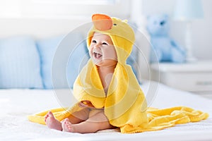 Cute baby after bath in yellow duck towel