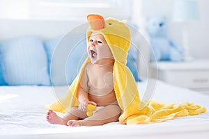 Cute baby after bath in yellow duck towel