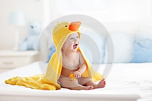 Cute baby after bath in yellow duck towel