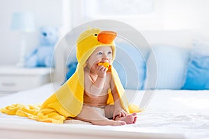 Cute baby after bath in yellow duck towel