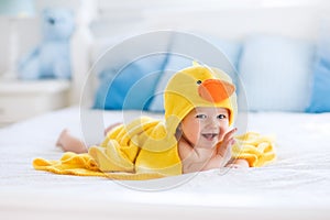 Cute baby after bath in yellow duck towel