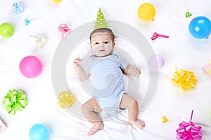 Cute baby with birthday decorations
