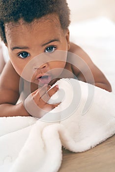 Cute baby, black child and crawling on blanket for play, fun and relax in nursery room. Adorable young african infant