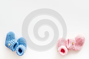 Cute baby booties for girl and boy on white background top view copyspace