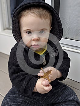 Cute baby boy in black hoodie