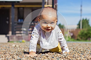 Cute baby boy crawling at playground outdoors