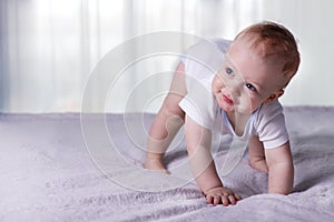 Cute baby boy doing first steps. Lovely infant kid begining to toddle photo