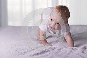 Cute baby boy doing first steps. Lovely infant kid begining to toddle.