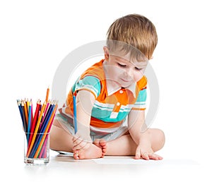 Cute baby boy drawing with color pencils