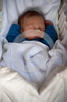 Cute baby boy fast asleep inside his crib