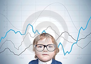 Cute baby boy in glasses and suit, graphs