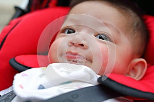 Cute baby boy happy playful bubbles saliva drool on child mouth