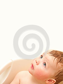 Cute baby boy looking up at copyspace