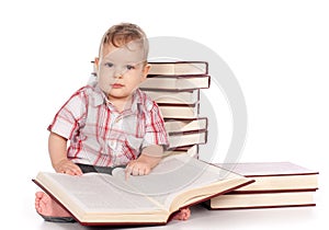 Cute baby boy with many books isolated on white