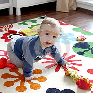 Cute baby boy on play mat