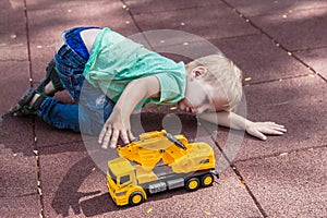 Cute baby boy playing alone, asocial child