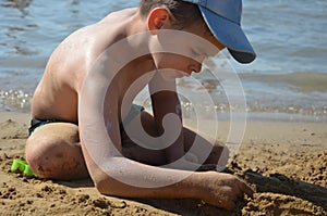 Cute baby boy playing with beach toys on tropical beach. playing on the beach on summer holidays. Children building a