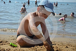 Cute baby boy playing with beach toys on tropical beach. playing on the beach on summer holidays. Children building a