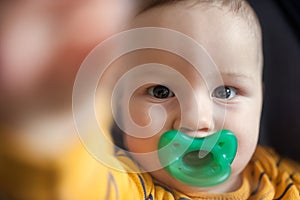 Cute baby boy stretches out his hand towards the camera