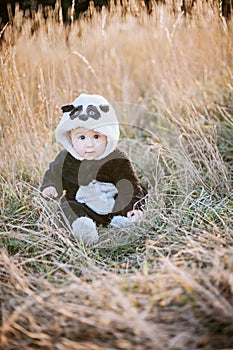 Cute baby boy wearing a Panda bear suit