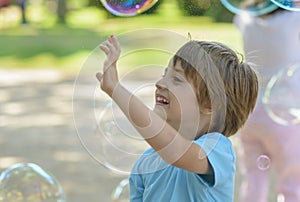 Cute Baby Catching Soap Bubbles