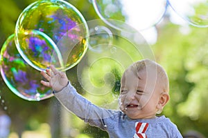 Cute Baby Catching Soap Bubbles