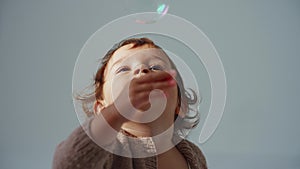 Cute Baby Catching Soap Bubbles in living room