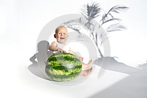 Cute baby, child, kid emotins. Funny toddler boy playing with watermelon, healthy fruit snack on white background, hot