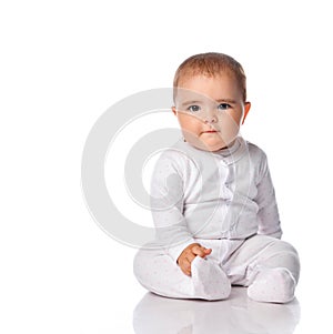 Cute baby child sitting on white floor background