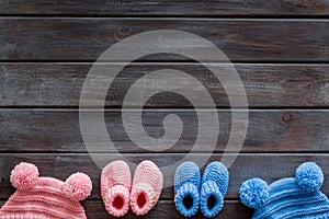 Cute baby clothes for girl and boy on wooden background top view copyspace