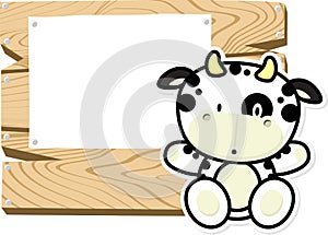 Cute baby cow on wooden board