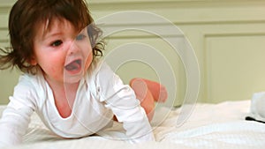 Cute baby crawling on the bed