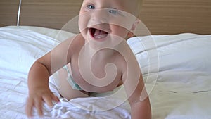 Cute baby crawling on bed
