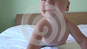 Cute baby crawling on bed