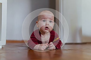 Cute baby crawling on the floor looking at parents