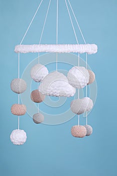 Cute baby crib mobile on light blue background