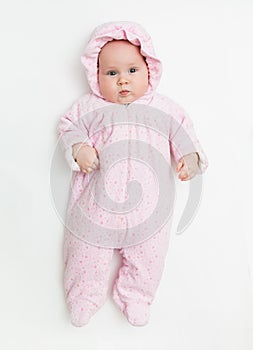 Cute baby dressed in warm overall for winter cold weather.