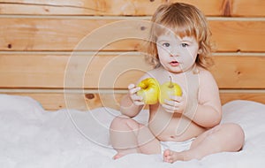 Cute baby eat apple. Solid food for infant. Child eating, nutrition concept.