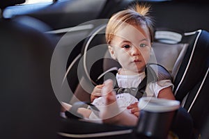 Cute baby girl in car seat