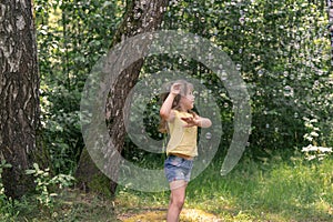 cute baby girl catches a lot of soap bubbles on a summer day