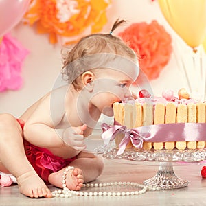 Cute baby girl celebrates birthday one year.