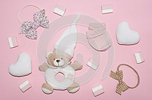 Cute baby girl clothes and accessories  soft white hearts  teddy bear  sweets  bows  socks. Happy Valentine day concept