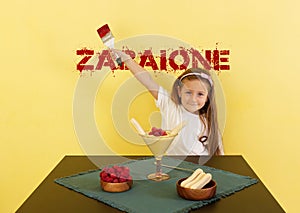 Cute baby girl with dessert and zabaione inscription.