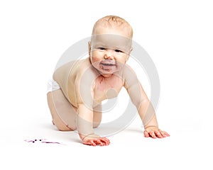 Cute baby girl dirty after eating berries crawling over white